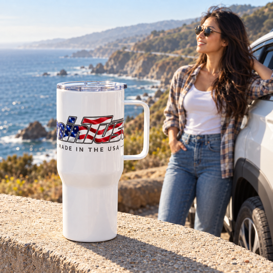Traveler holding the minTusa Star Spangled travel mug at a California coastal overlook
