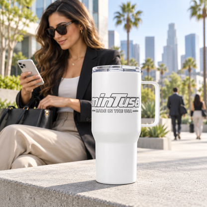 White minTusa Signature travel mug in a bright Los Angeles commuter plaza