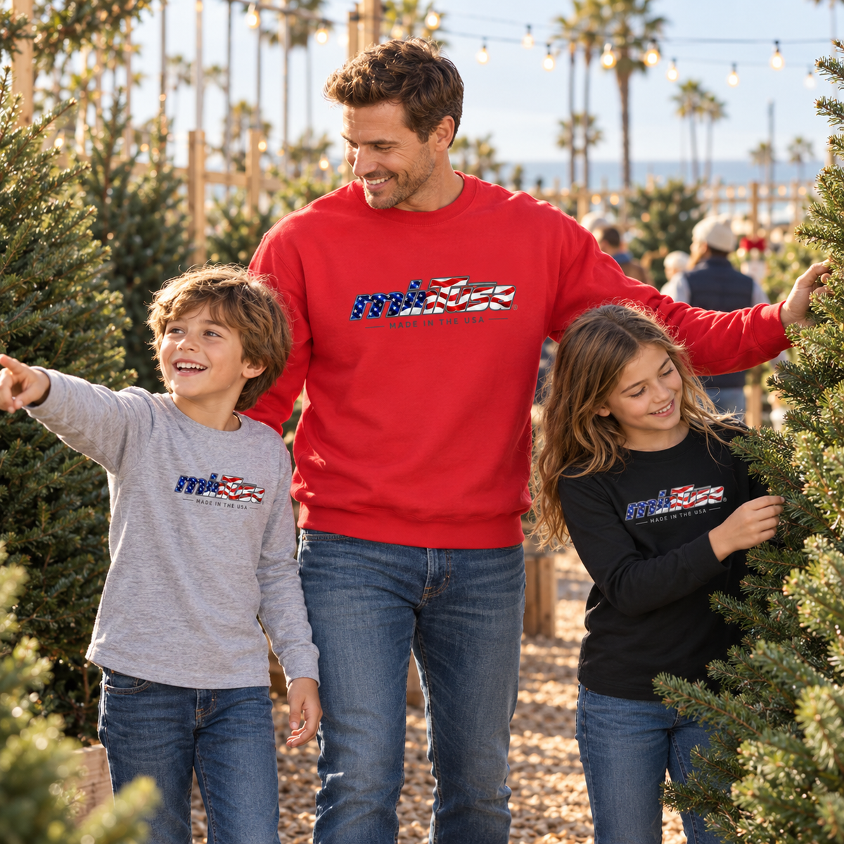 Dad wearing the Team Red minTusa Star Spangled premium sweatshirt at a Christmas tree sale with his children