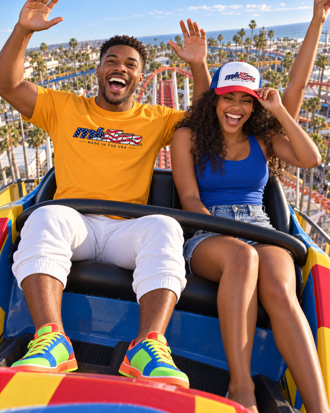 Young couple enjoying a Southern California roller coaster in the Team Gold minTusa Star Spangled T-shirt and trucker cap